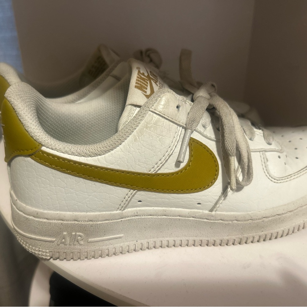 Nike White and Gold Sneakers with Bold Swoosh